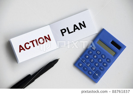 Action plan text on notepad with pen and calculator. 88761837