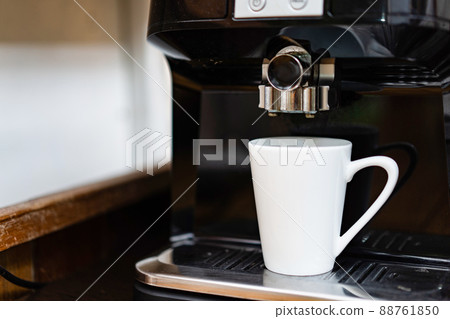 White Coffee cup standby on the professional coffee machine ready to make fresh hot coffee. White Coffee cup standby on the professional coffee machine ready to make fresh hot coffee. 88761850