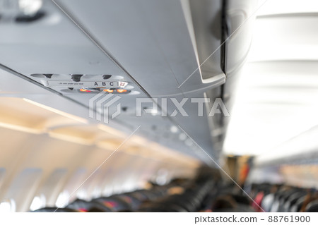 closeup airplane Console panel; lamp, light, need help button, air condition, sefty belt and no smoking lighting sign. closeup airplane Console panel; lamp, light, need help button, air condition, sefty belt and no smoking lighting sign. 88761900