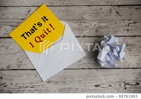 Yellow notepad with text - That's it, I quit with envelope and crumpled paper background. Yellow notepad with text - That's it, I quit with envelope and crumpled paper background. 88761903