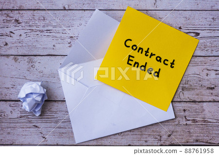 Contract ended text on yellow notepad with envelope background. Contract ended text on yellow notepad with envelope background. 88761958