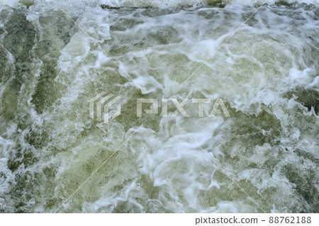 White foam of seething water and whirlpools. 88762188