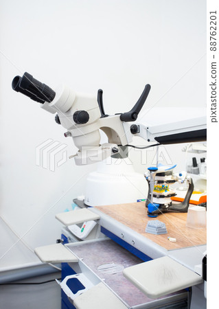 Microscope in a dental laboratory, a technician's workplace in a dental laboratory Microscope in a dental laboratory, a technician's workplace in a dental laboratory 88762201