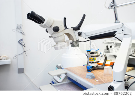 Microscope in a dental laboratory, a technician's workplace in a dental laboratory Microscope in a dental laboratory, a technician's workplace in a dental laboratory 88762202