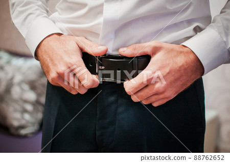 Close up man holding hands on his belt 88762652