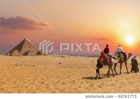 The Pyramid complex of Giza and arabs on camels, Egypt 88763773