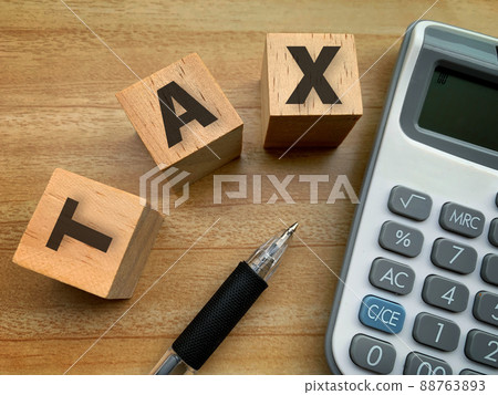 top view of Tax on wooden cube with calculation and pen background. Taxation concept. 88763893