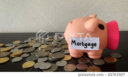 Saving money into piggy bank for mortgage payment. Money concept. Saving money into piggy bank for mortgage payment. Money concept. 88763907