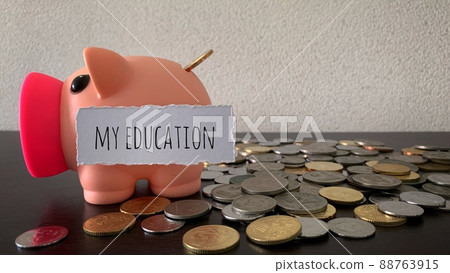 Saving money into piggy bank for my education. Money concept. Saving money into piggy bank for my education. Money concept. 88763915