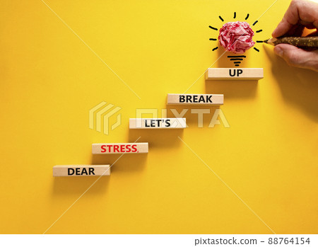 Stress break up symbol. Concept words Dear stress let is break up on wooden blocks. Businessman hand. Beautiful yellow table and background. Business motivational stress break up concept. Copy space. 88764154