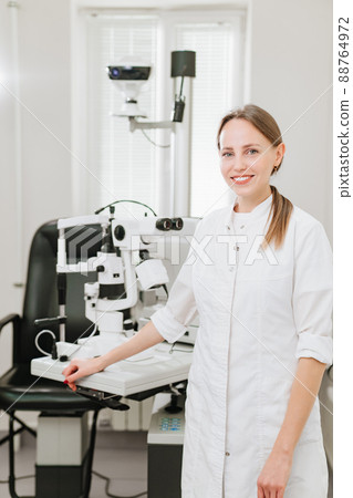 Attractive woman ophthalmologist in ophthalmology clinic. optics salon. 88764972