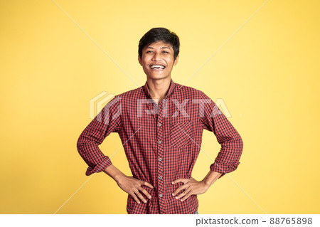happy asian young man laughing naturally on studio background 88765898