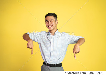 excited young man with fingers pointing down 88765975