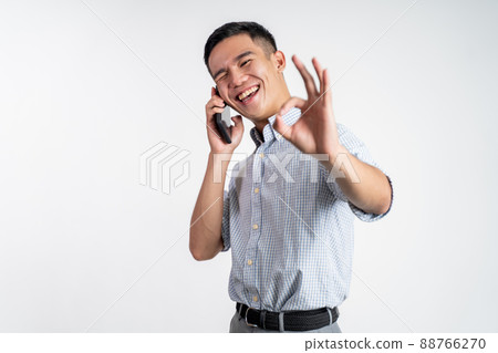 man showing okay gesture while making phone call man showing okay gesture while making phone call 88766270