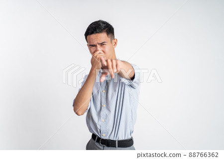 man cover his nose and feeling disgusted by the smell 88766362