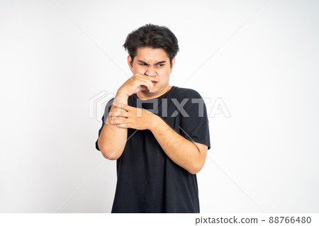 man cover his nose and feeling disgusted by the smell man cover his nose and feeling disgusted by the smell 88766480