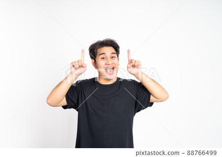 excited young man with two fingers pointing up excited young man with two fingers pointing up 88766499