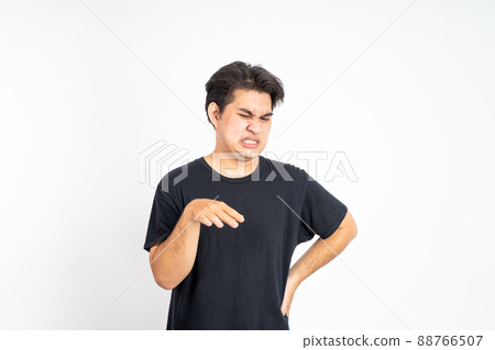asian young man with disgusting expression isolated over white background asian young man with disgusting expression isolated over white background 88766507