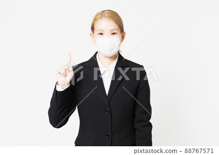 Young woman showing points wearing a mask 88767571
