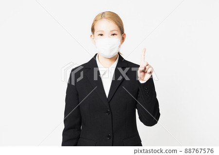 Young woman showing points wearing a mask 88767576