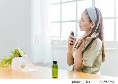 Middle-aged women using hair care products (smiles) 88768290