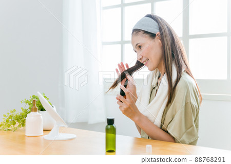 Middle-aged women using hair care products (smiles) 88768291