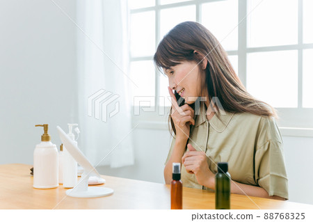 Middle-aged woman looking in the mirror (nose) Middle-aged woman looking in the mirror (nose) 88768325
