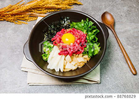 Korean food yukhoe bibimbap dish in black bowl 88768829
