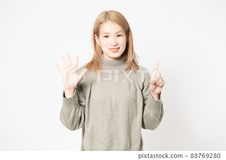 Young woman representing the number 6 by hand Young woman representing the number 6 by hand 88769280