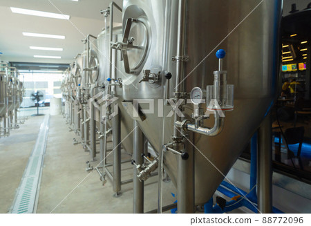 Brewery. Interior of a alcohol or beer drink machine room in kitchen bar of cafe or coffee shop. Business water pipe service. Fermenting. 88772096
