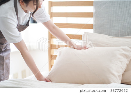 Asian woman making a bed in the bedroom 88772652