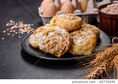 Homemade glazed puff pastry cinnamon rolls with custard and raisins 88776040