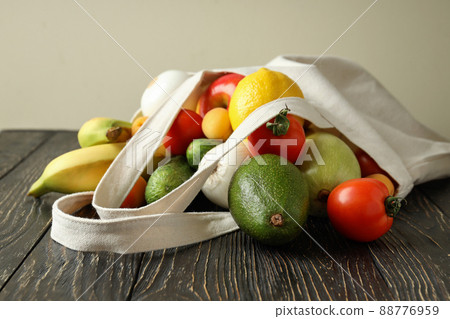 Cotton bag with vegetables and fruits on wooden table Cotton bag with vegetables and fruits on wooden table 88776959