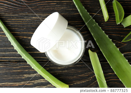 Aloe vera leaves, slices and cream on wooden background 88777325