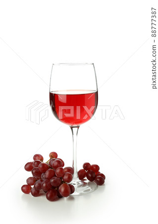 Glass of red wine and grape isolated on white background Glass of red wine and grape isolated on white background 88777387