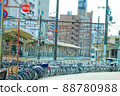 Bicycles parked in front of the station and the platform of the station 88780988