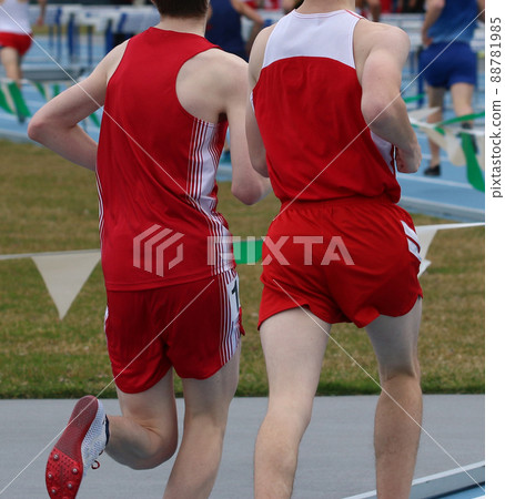 Rear view of boys running a race on an outdoor track 88781985
