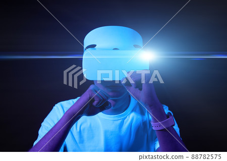 Man with virtual reality headset is playing game and fighting. 88782575