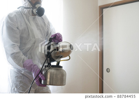 Workers disinfecting indoors with a sprayer 88784455
