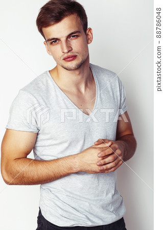 young handsome teenage hipster guy posing emotional, happy smiling against white background isolated, lifestyle people concept 88786048