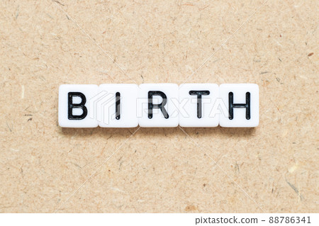 White tile alphabet letter with word birth on wood background White tile alphabet letter with word birth on wood background 88786341