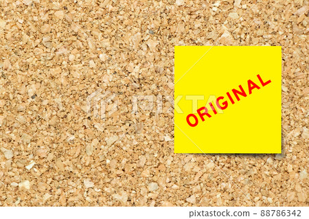 Yellow note paper with word original on cork board background with copy space 88786342