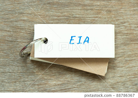 Flash card with handwriting word EIA (abbreviation of Environmental Impact Assessment) on wood background 88786367