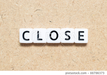 White tile alphabet letter with word close on wood background White tile alphabet letter with word close on wood background 88786373
