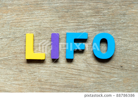 Color alphabet letter in word LIFO (abbreviation of last in first out) on wood background 88786386