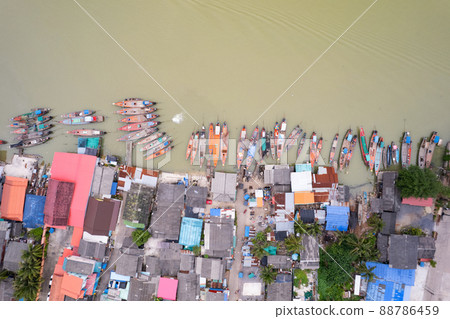 Aerial view top view of the fisherman village with fishing boats and house roof at the pier in suratthani Thailand. high angle view 88786459