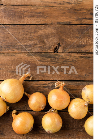 Fresh onion bulbs on rustic wooden table with copyspace. Top view Fresh onion bulbs on rustic wooden table with copyspace. Top view 88786728