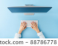 Overhead shot of woman hands working on computer on blue background. Office desktop. Flat lay 88786778