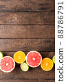 Juicy citruses on wooden table. Top view 88786791