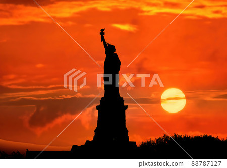 Silhouette of Statue of Liberty over dramatic red sky sunset, New York, USA 88787127